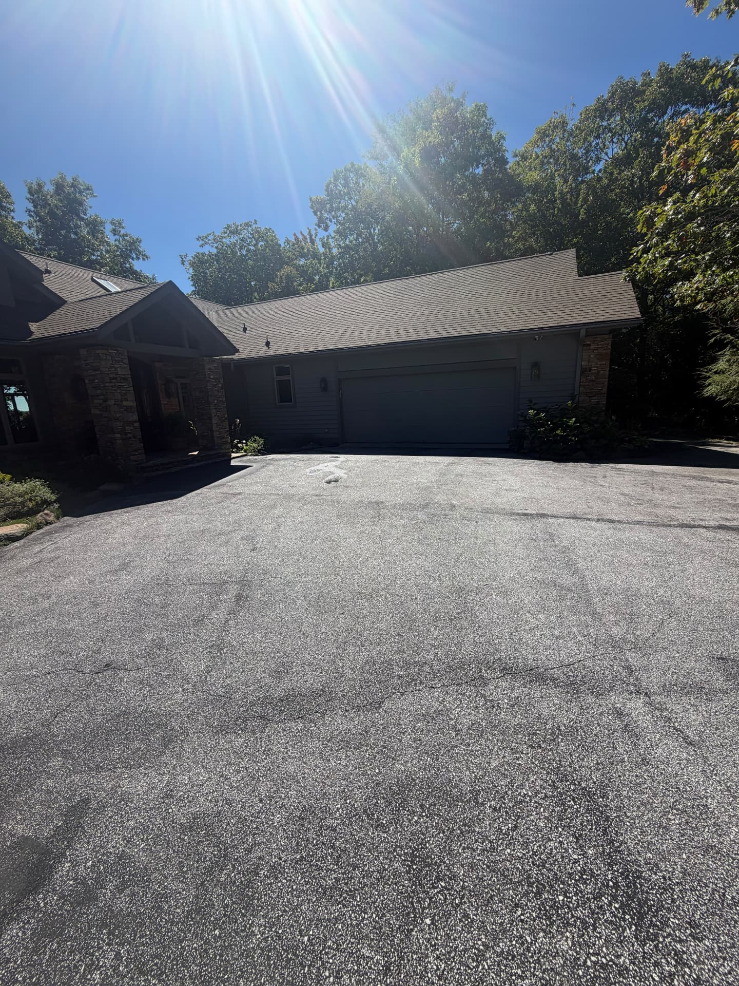 Large mountain home driveway and garage area before sealcoating